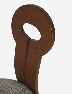 Detailed view of the eyelet back rest on the Whit honey wood sculptural dining chair by sarah sherman samuel