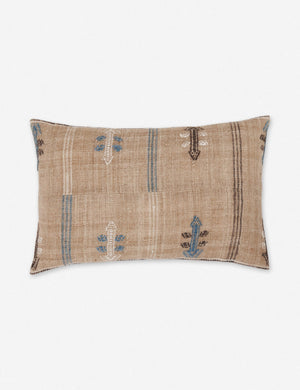Rica taupe lumbar throw pillow with blue, white, and black woven arrow-like designs