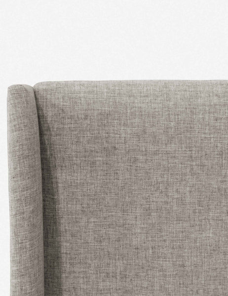 #color::zuma-gray #size::cal-king #size::full #size::king #size::queen #size::twin | Close-up of the subtle winged headboard and trim lines on the Adara light gray linen upholstered bed.