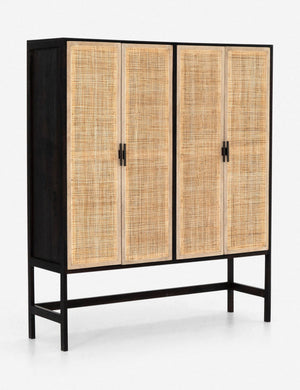 Angled view of the Hannah black mango wood cabinet with cane doors