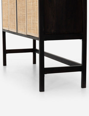 Close-up of the lower half of the Hannah black mango wood cabinet with cane doors