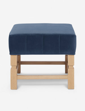 Ambleside Harbor blue velvet upholstered ottoman by Ginny Macdonald with a carved frame and vertical channeling on the cushion