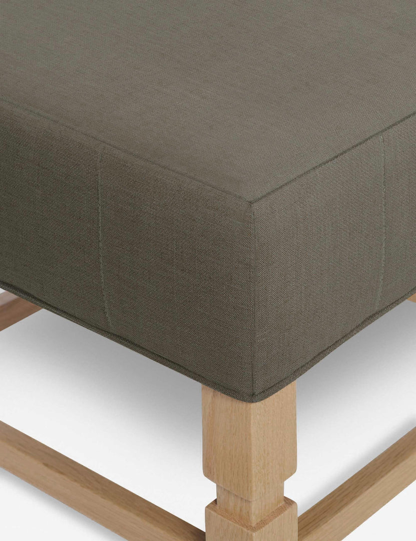 #color::loden | Close-up of the corner on the cushion of the Ambleside Loden gray linen ottoman