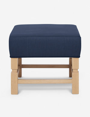Ambleside Dark Blue linen upholstered ottoman by Ginny Macdonald with a carved frame and vertical channeling on the cushion