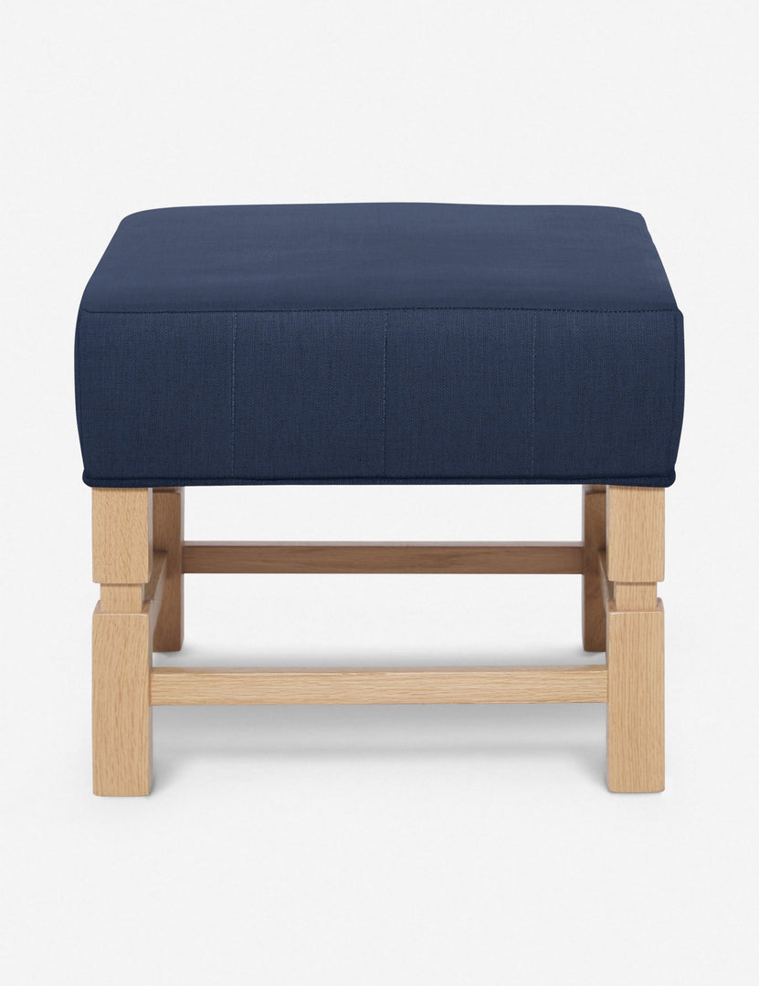 #color::dark-blue | Ambleside Dark Blue linen upholstered ottoman by Ginny Macdonald with a carved frame and vertical channeling on the cushion
