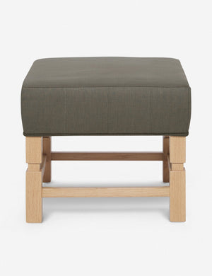 Ambleside Loden gray linen upholstered ottoman by Ginny Macdonald with a carved frame and vertical channeling on the cushion