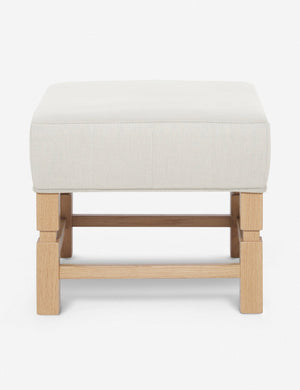 Ambleside Natural linen upholstered ottoman by Ginny Macdonald with a carved frame and vertical channeling on the cushion