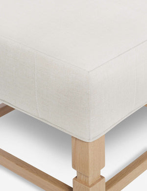 Close-up of the corner on the cushion of the Ambleside Natural linen ottoman