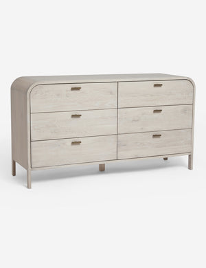 Angled view of the Brooke whitewashed oak 6-drawer rounded dresser with iron drawer pulls