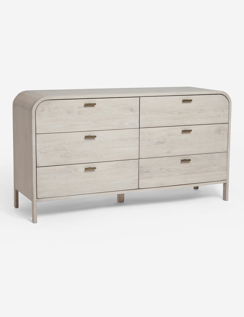 #color::natural | Angled view of the Brooke whitewashed oak 6-drawer rounded dresser with iron drawer pulls