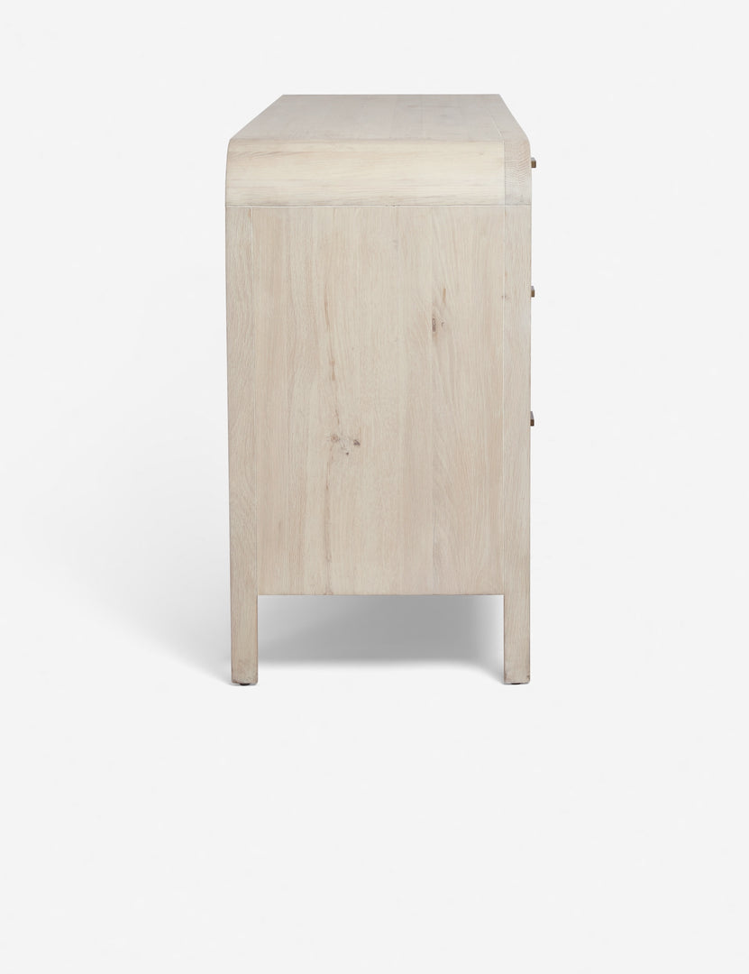 #color::natural | Side  view of the Brooke whitewashed oak 6-drawer rounded dresser with iron drawer pulls