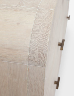 Top-down close-up of the arched corner on the Brooke whitewashed oak 6-drawer rounded dresser with iron drawer pulls