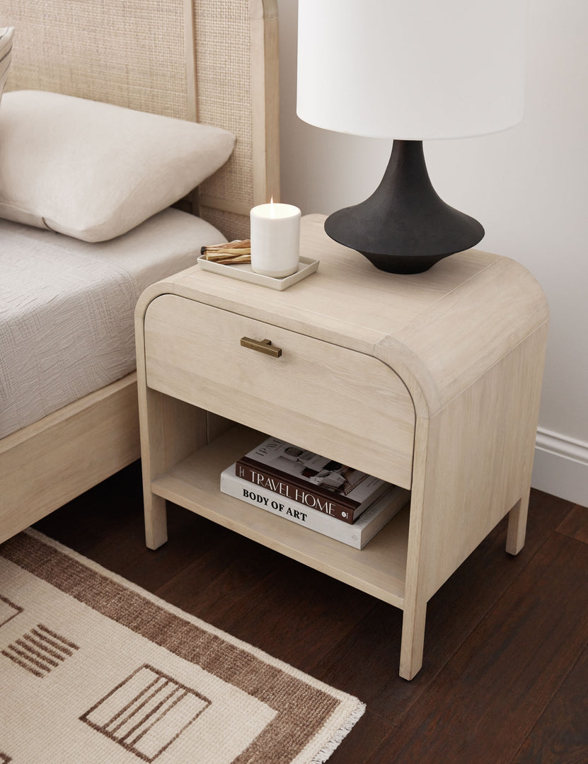 #color::natural | The Brooke one drawer whitewashed nightstand sits next to the Brooke platform bed next to a patterned rug