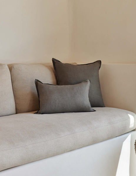 #color::conifer #style::square | The arlo Conifer gray flax linen pillow in its lumber and square sizes sit together on a natural linen sofa