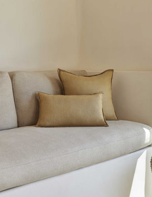 The arlo Marigold flax linen pillow in its lumber and square sizes sit together on a natural linen sofa