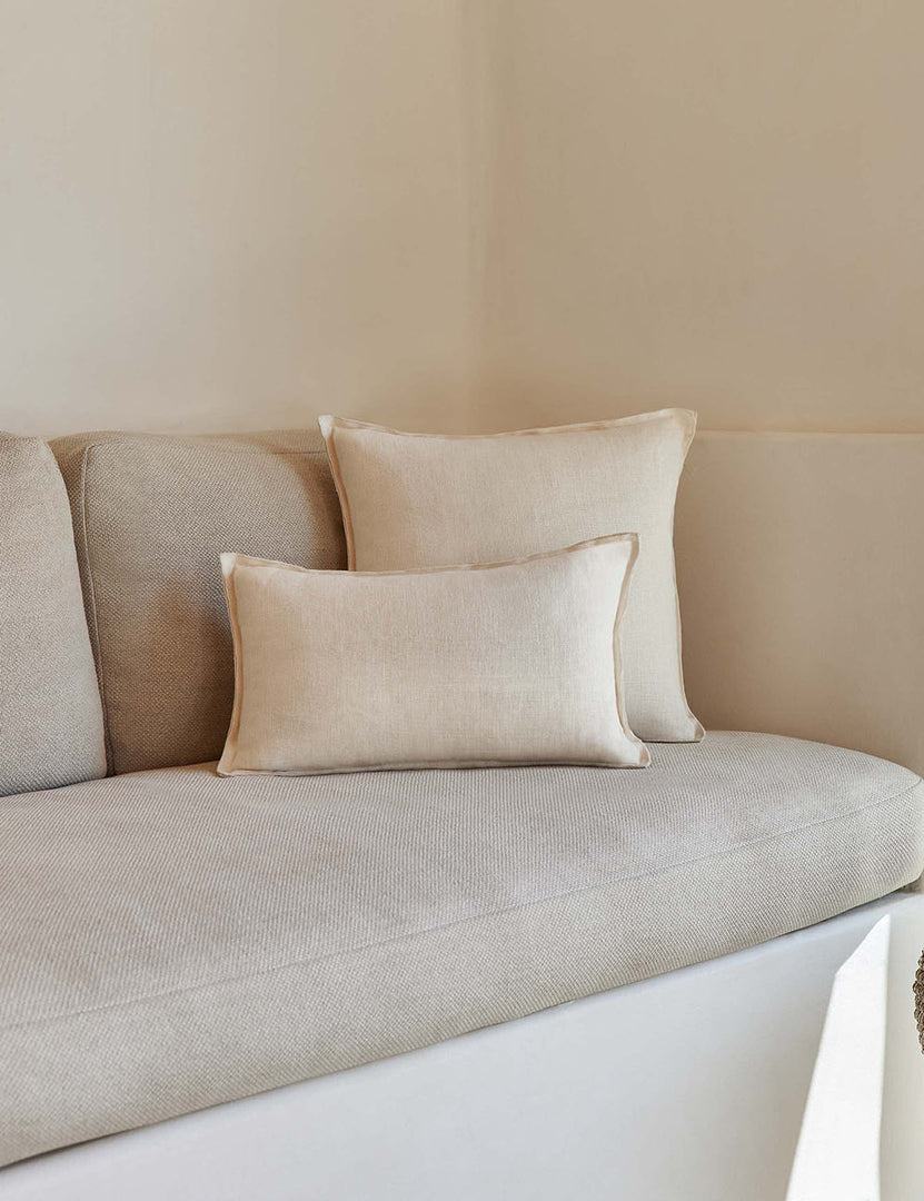 #color::light-natural #style::square | The arlo Light Natural flax linen pillow in its lumber and square sizes sit together on a natural linen sofa