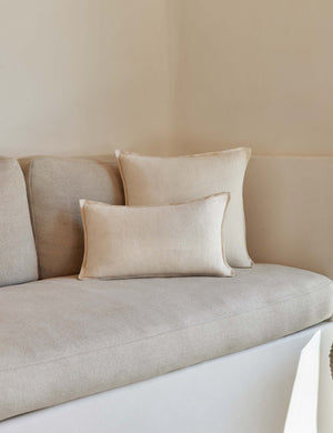 The arlo Light Natural flax linen pillow in its lumber and square sizes sit together on a natural linen sofa