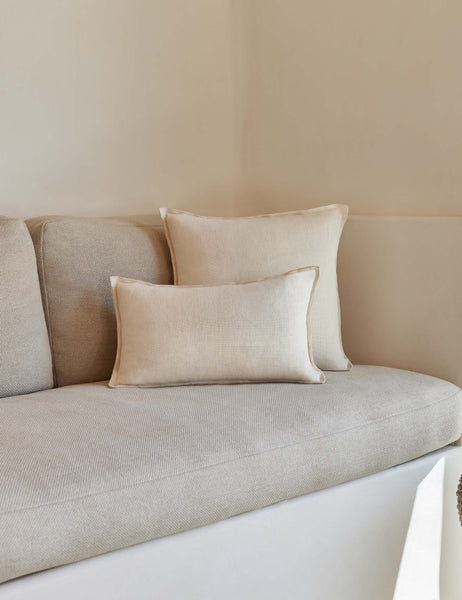 #color::light-natural #style::lumbar | The arlo Light Natural flax linen pillow in its lumber and square sizes sit together on a natural linen sofa