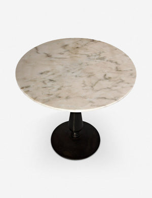 Angled top view of the Auriel side table with marble table top and cast iron base