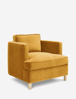 Angled view of the Belmont goldenrod velvet accent chair