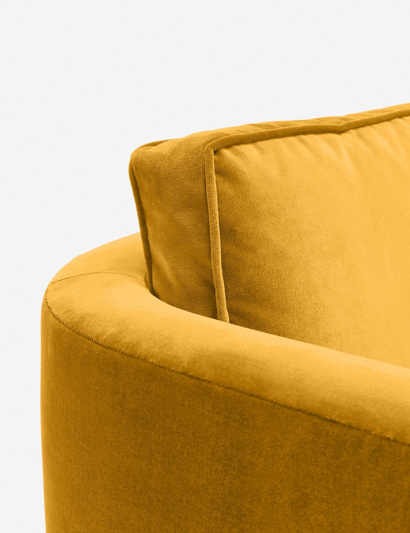 #color::goldenrod-velvet | Close-up of the curved back on the Belmont goldenrod velvet accent chair