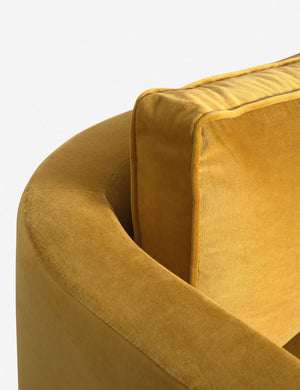 The curved back and arm of the Goldenrod Velvet Belmont Sofa