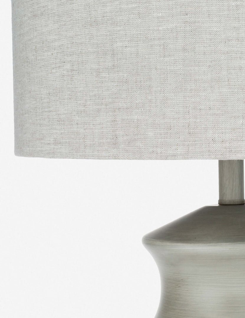 | Close-up of the natural linen material on the finial of the Bhavanah Table Lamp with a gray spindle designed base