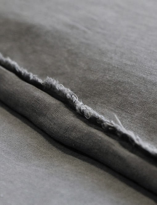 #color::midnight #size::king #size::queen | Close-up of the dark gray blair stonewashed linen duvet by pom pom at home
