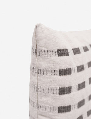 Corner of the Bertu pumice gray pillow with a woven dash pattern by Bolé Road Textiles