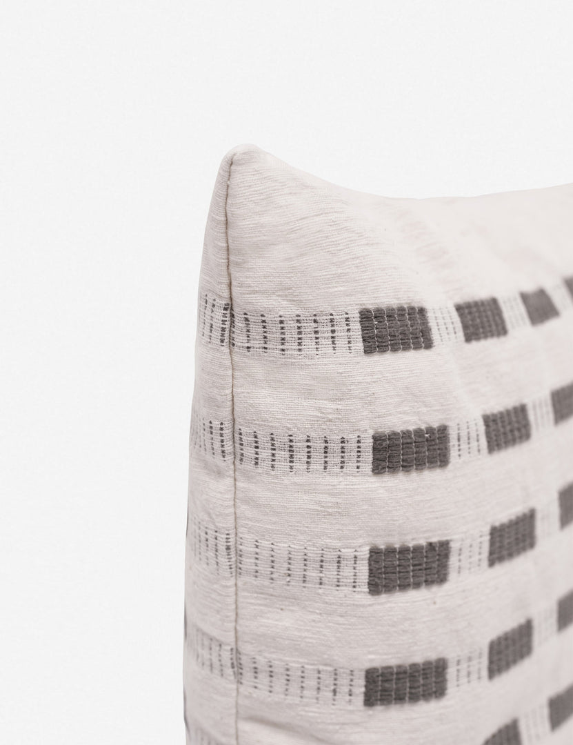 #color::pumice | Corner of the Bertu pumice gray pillow with a woven dash pattern by Bolé Road Textiles