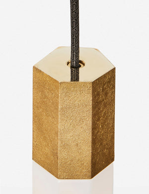 Close-up of the sand casted brass hardware on the Basalt slender hexagonal 3-light pendant light by tala