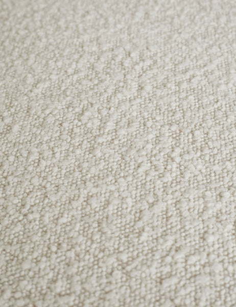 #color::cream | Close-up of the white boucle fabric on the Celeste honey wood accent chair with wishbone frame