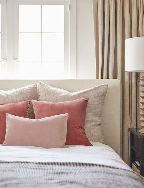 #color::rosewater #style::lumbar | Charlotte rosewater pink square velvet pillow sits on a neutral linen framed bed with striped linens and dark pink throw pillows