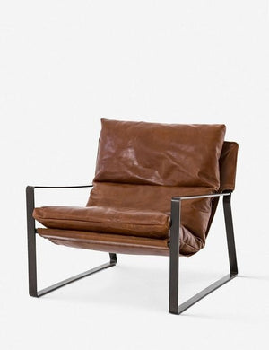 Angled right side view of brown leather Marlyne sling-back accent chair with black metal frame