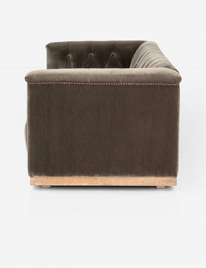 Side view of Afia tufted gray-brown velvet sofa with nailhead trim and light wood base