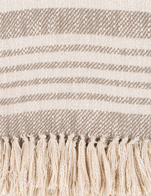 Close-up of the edge of the Elulia woven two-tone taupe throw with fringed ends