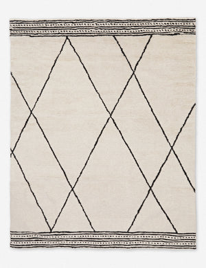 Danica ivory wool moroccan style rug with a black striped, diamond, and dotted pattern