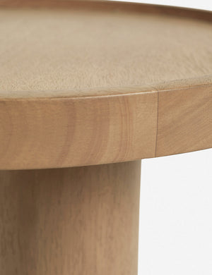 Close-up of the rim on the surface of the Delta natural wooden side table with pedestal base