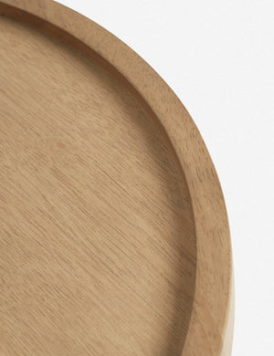 Bird’s-eye view of the rim on the surface of the Delta natural wooden side table with pedestal base