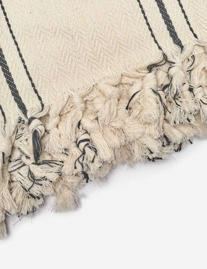 Close-up of the fringed ends on the Monte viso natural and black striped bed cover by House No. 23