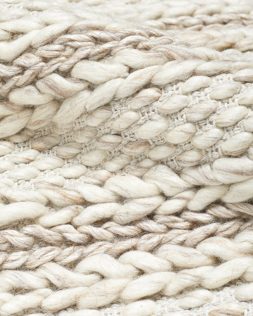 #size::3--x-5- #size::5--x-8- #size::8--x-10- #size::9--x-12- #color::soft-sand #size::10--x-14- | Detailed view of the braided texture on the Estie white rug | Detailed shot of the thickly braided construction on the Estie rug