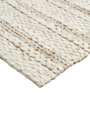 Detailed view of the corner and the braided texture of the of the Estie white rug