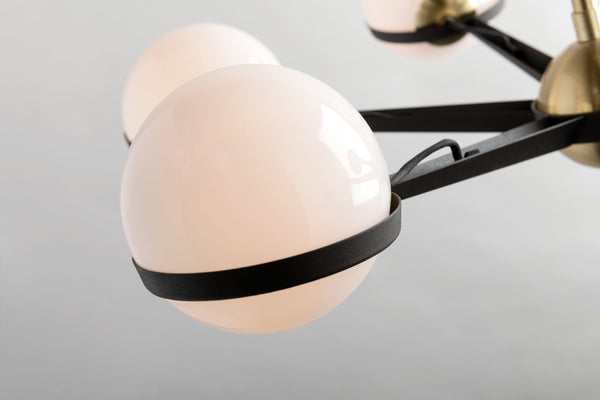| Close-up of the spherical lighting fixtures on the Adeline black and brass retro chandelier 