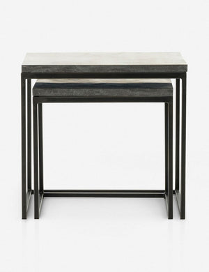 View of the Ginette bluestone nesting side tables with black metal legs with the smaller table fully nested under the larger table