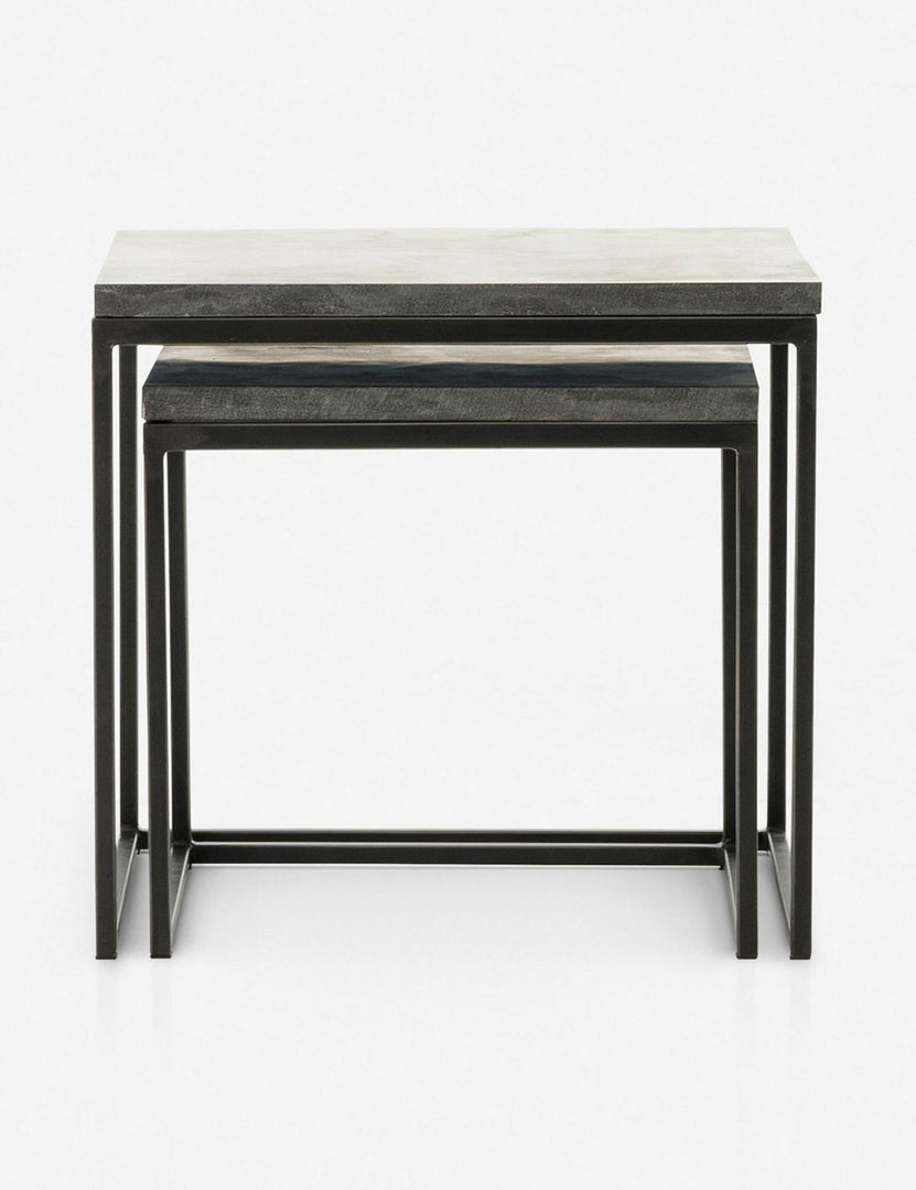 | View of the Ginette bluestone nesting side tables with black metal legs with the smaller table fully nested under the larger table
