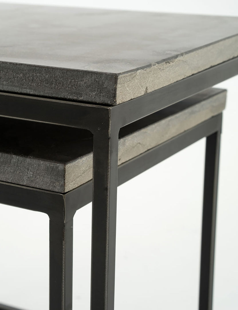 | Close-up of the corners of the Ginette bluestone nesting side tables with black metal legs