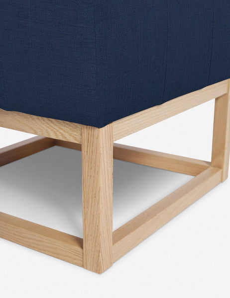#color::dark-blue | Close up of the airy wooden frame on the bottom of the Grasmere Dark Blue Linen Ottoman