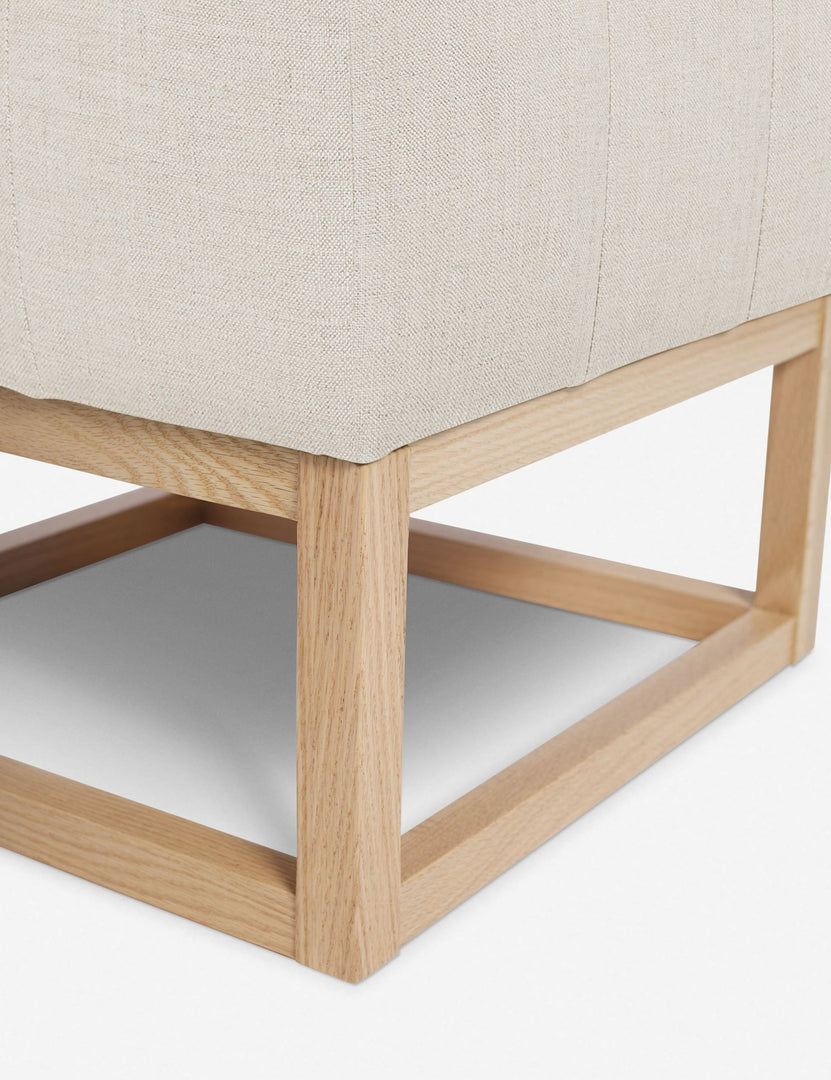 #color::natural | Close up of the airy wooden frame on the bottom of the Grasmere Natural Linen Ottoman