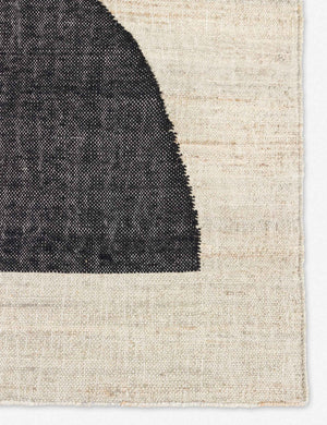 Close-up of the black semi-circle on the Goubi flatweave, neutral toned area Rug by Lemieux et Cie x Momeni