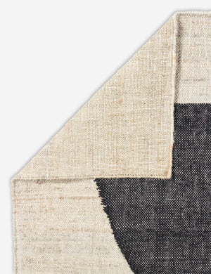 Close-up of the folded in corner of the Goubi flatweave, neutral toned area Rug by Lemieux et Cie x Momeni